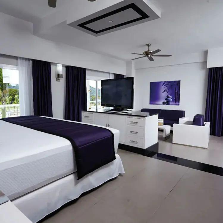 Modern hotel suite with purple accents and ocean views at Riu Palace Costa Rica, Papagayo