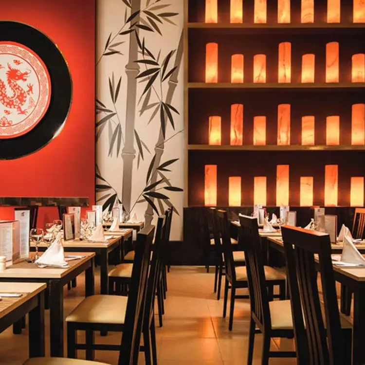 Bamboo Asian restaurant dining room with dragon decor and lit lanterns at Riu Reggae, Montego Bay