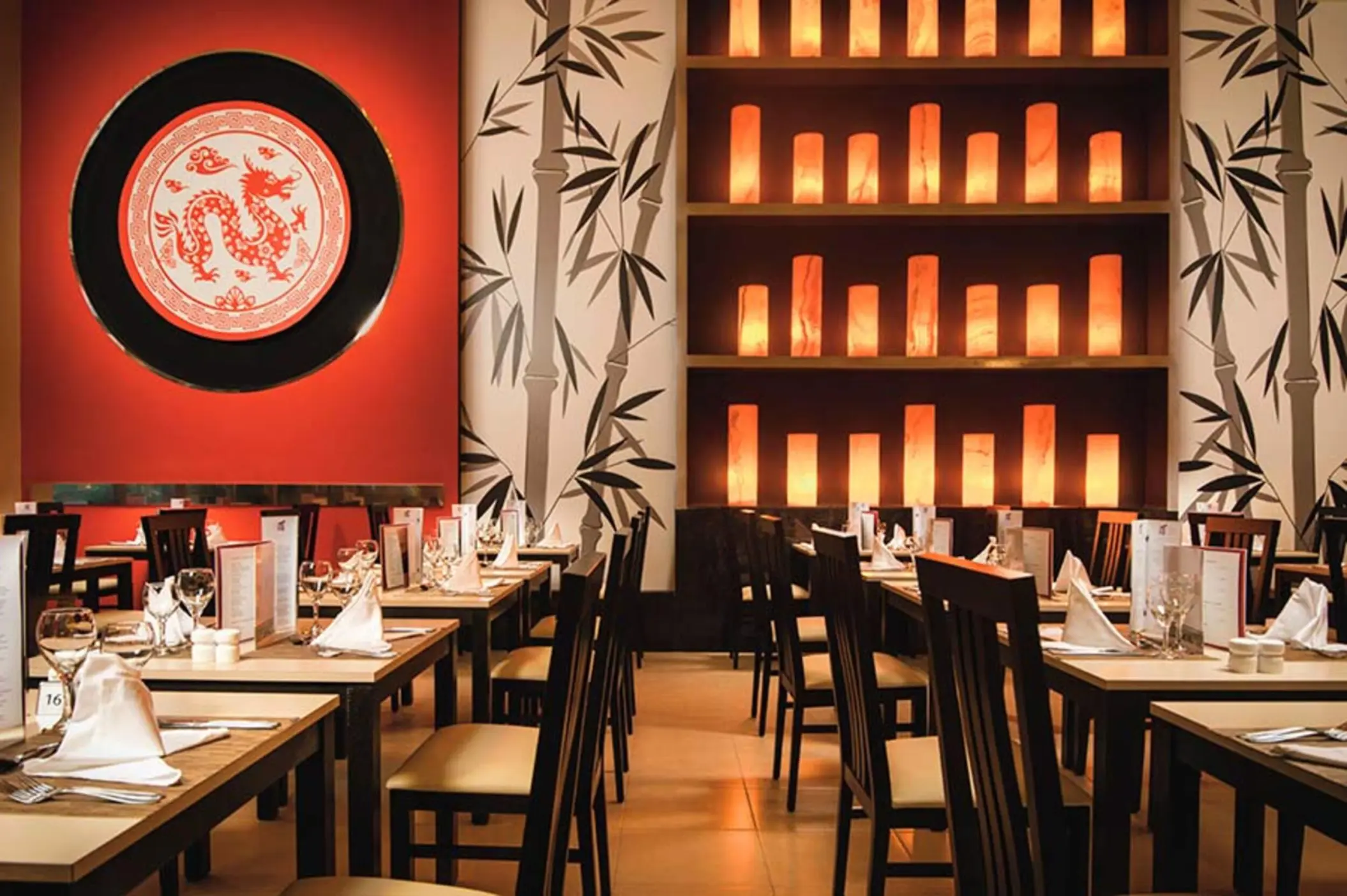Bamboo Asian restaurant dining room with dragon decor and lit lanterns at Riu Reggae, Montego Bay
