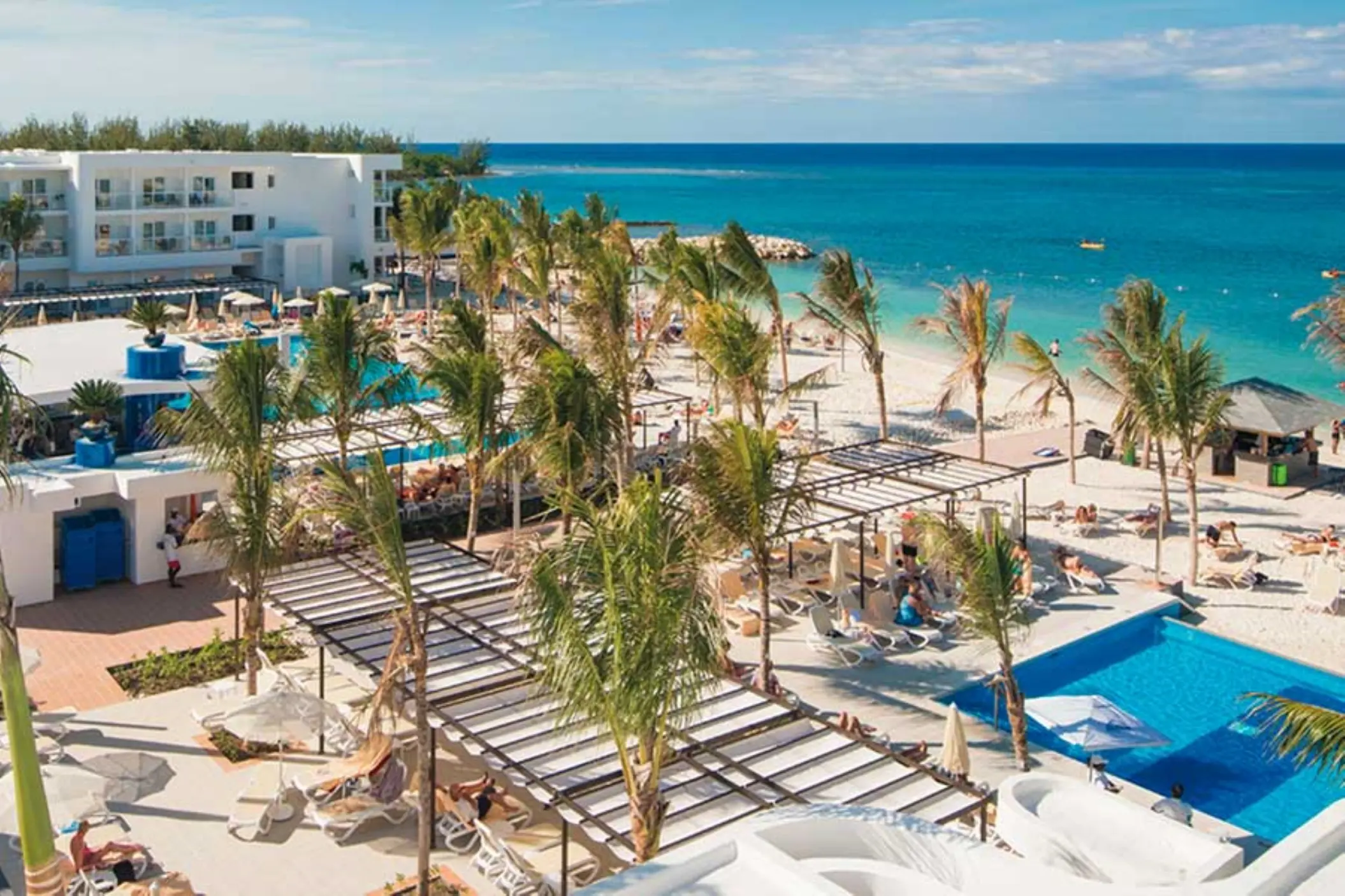 Aerial view of swimming pools and palm trees on the beach at Riu Reggae, Montego Bay