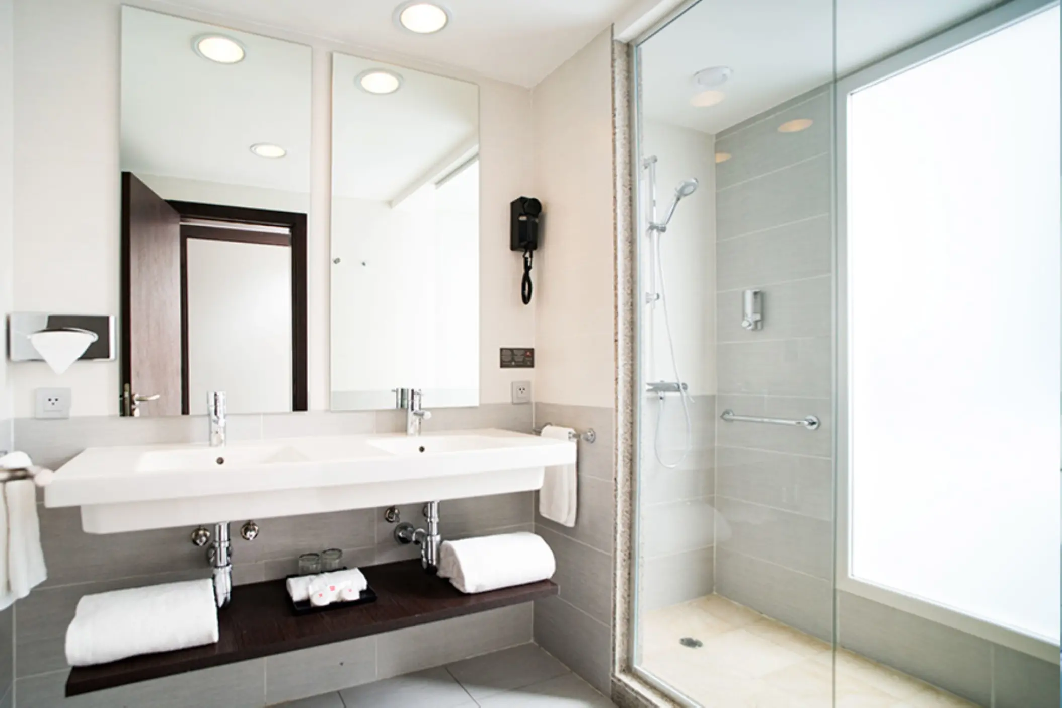 Modern suite bathroom with double vanity and glass walk-in shower at Riu Reggae, Montego Bay