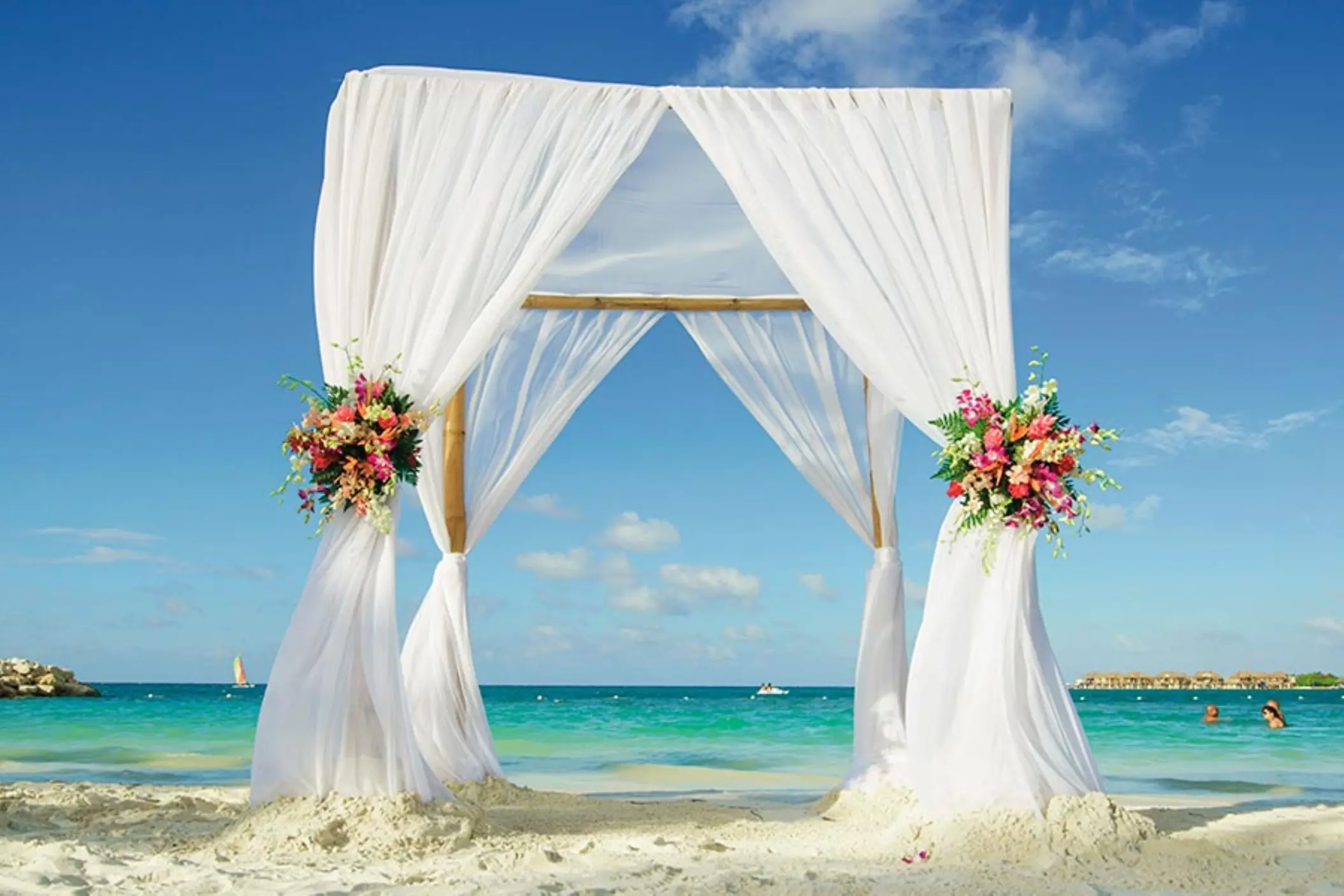 Beachfront wedding ceremony arch with white fabric at Riu Reggae, Montego Bay