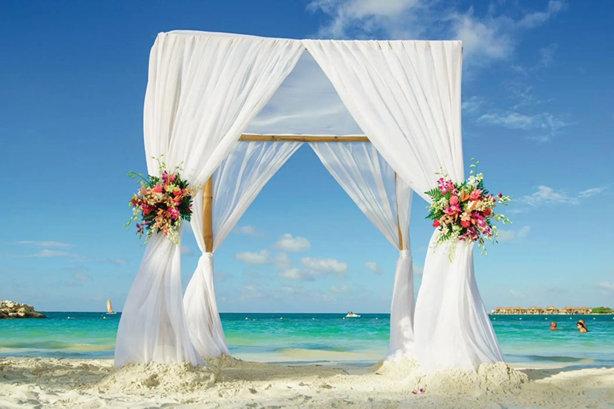 Beachfront wedding ceremony arch with white fabric at Riu Reggae, Montego Bay