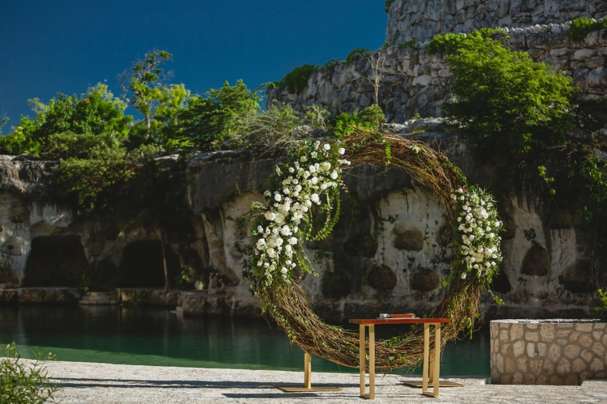 Floral circular arch for a wedding ceremony by the river at Hotel Xcaret Mexico, Riviera Maya