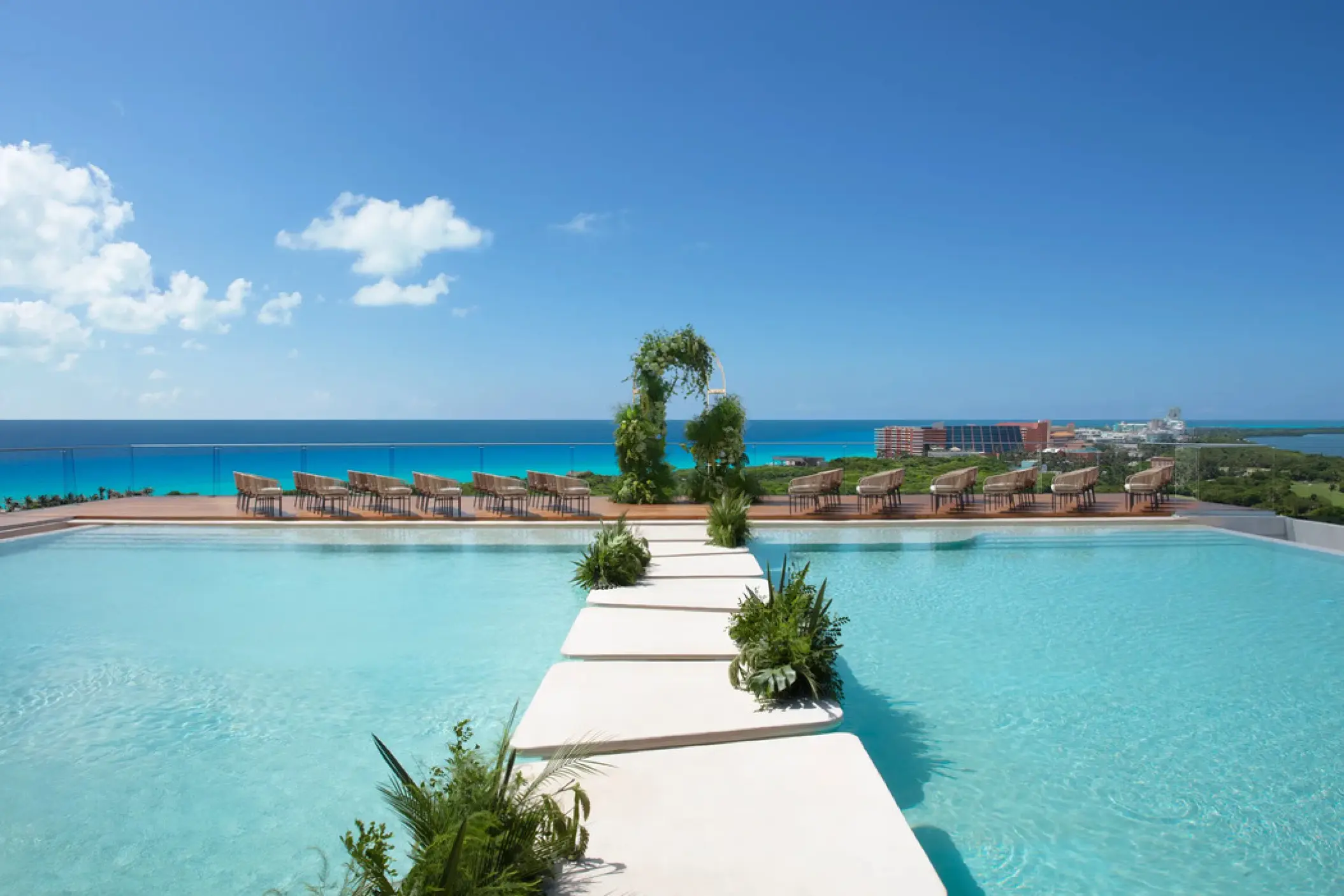 Rooftop wedding ceremony venue with pool aisle and ocean views at Hyatt Vivid Grand Island, Cancun