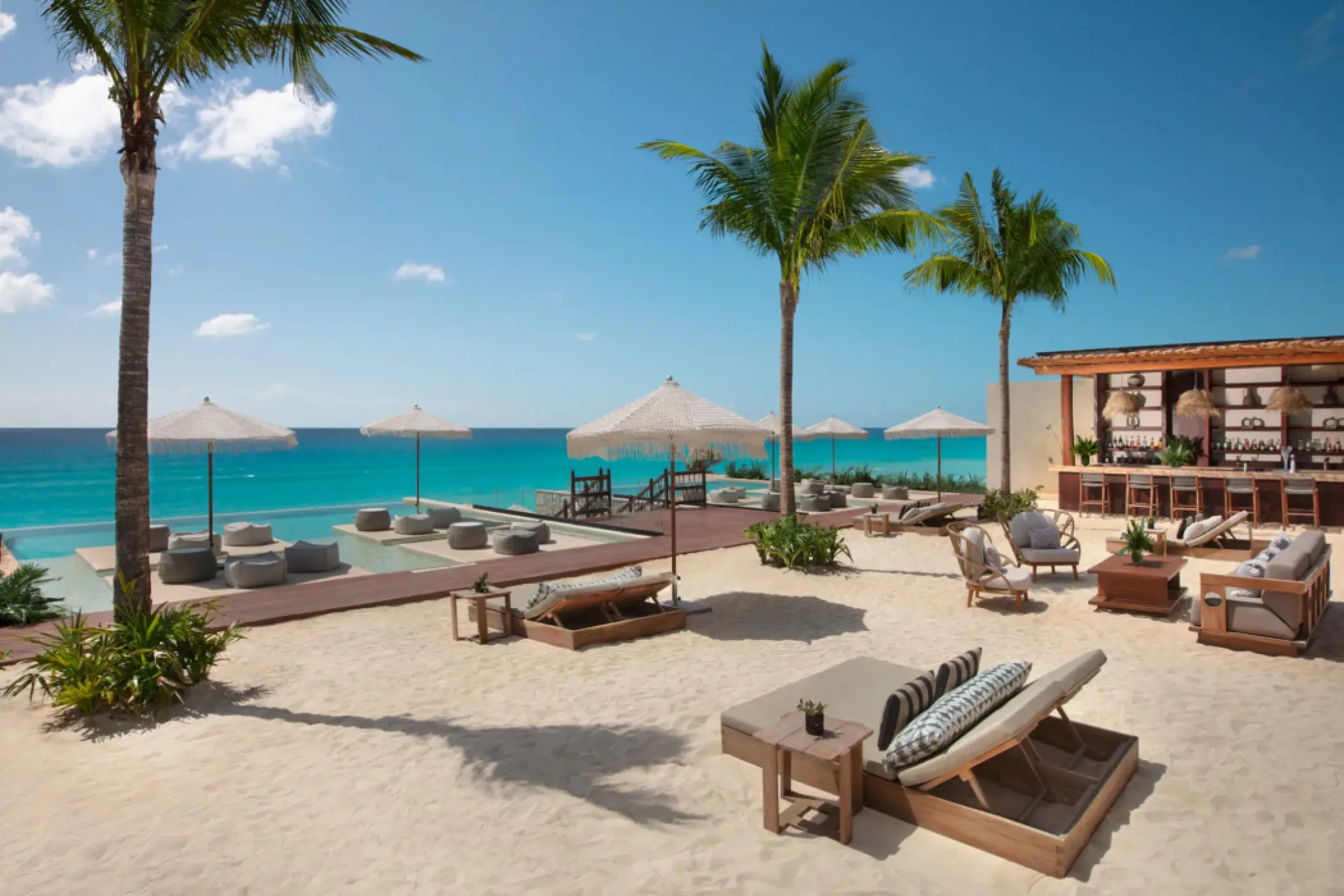 Cobalt rooftop deck beach club with lounge chairs and bar at Hyatt Vivid Grand Island, Cancun
