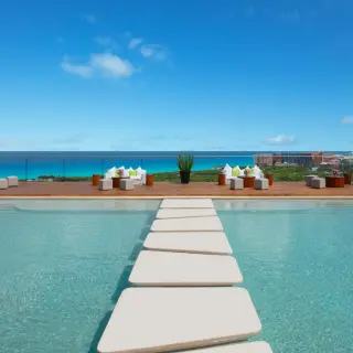 Cobalt rooftop deck wedding venue with pool stepping stones at Hyatt Vivid Grand Island, Cancun