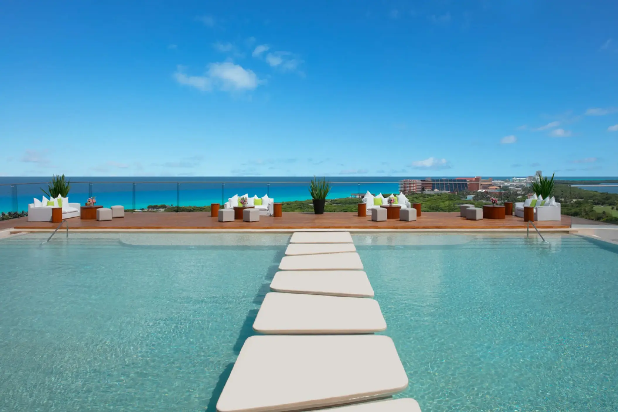 Cobalt rooftop deck wedding venue with pool stepping stones at Hyatt Vivid Grand Island, Cancun