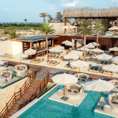 Ennea Beach Club wedding reception venue with lounge pools and umbrellas at Hyatt Vivid Grand Island, Cancun