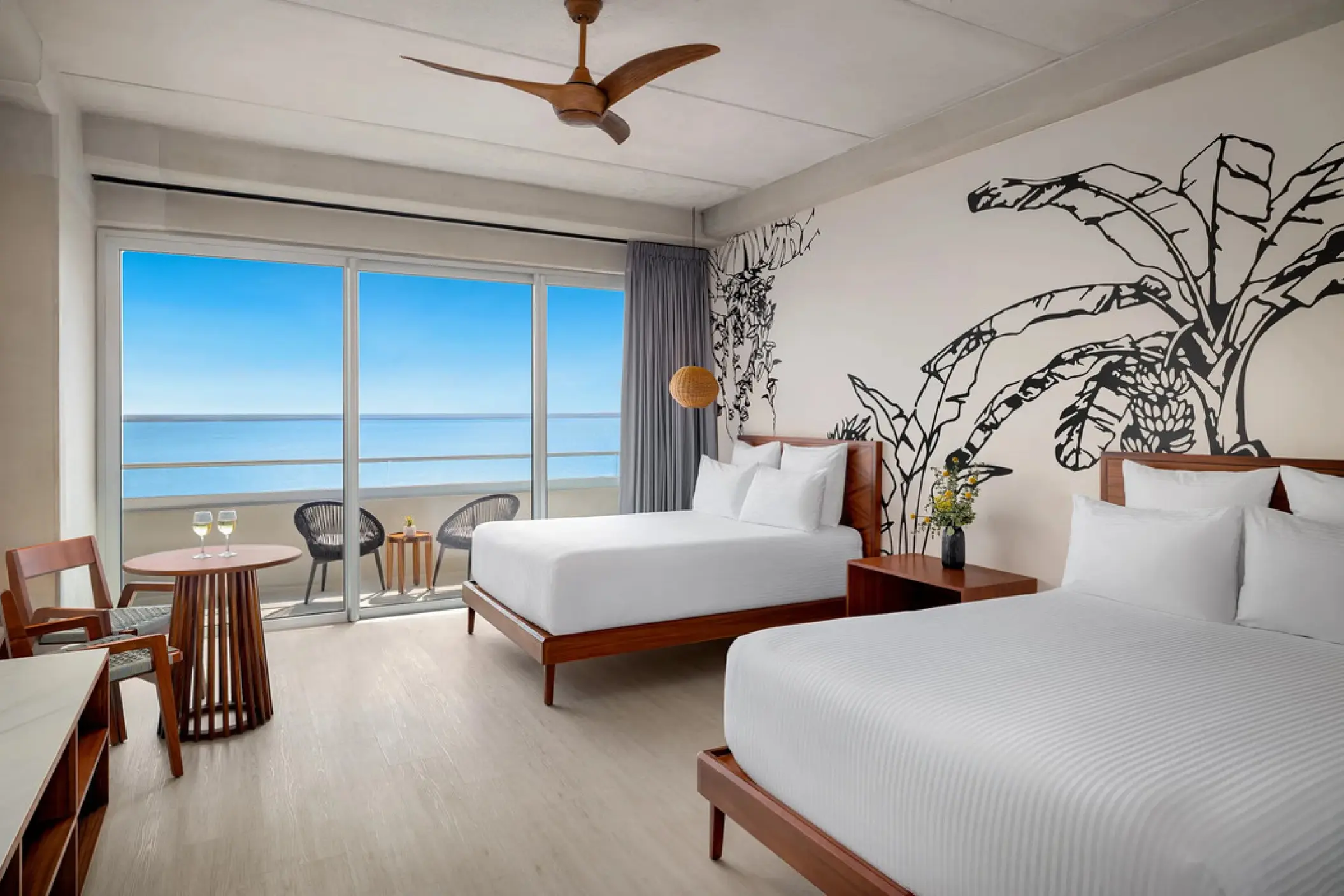 Junior suite with two beds and a private oceanfront balcony at Hyatt Vivid Grand Island, Cancun