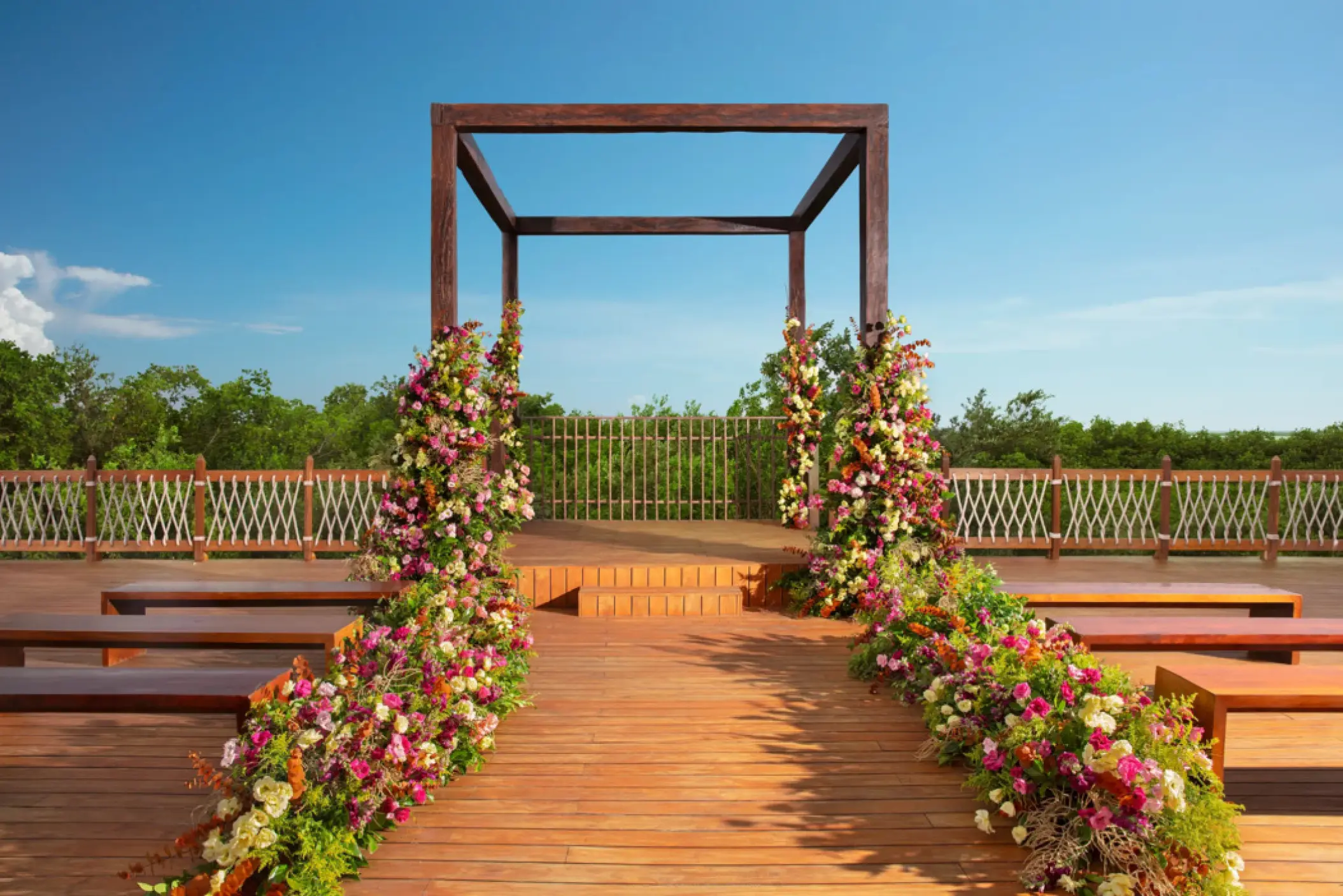 Wooden rooftop wedding ceremony gazebo with floral arrangements at Hyatt Vivid Grand Island, Cancun