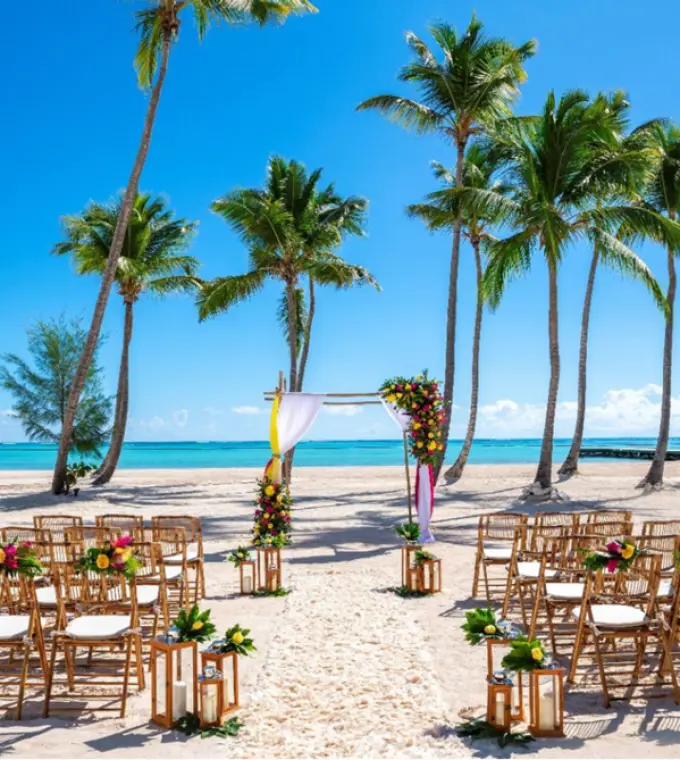 Beach wedding ceremony with bamboo chairs and palm trees at Hyatt Zilara Cap Cana, Punta Cana