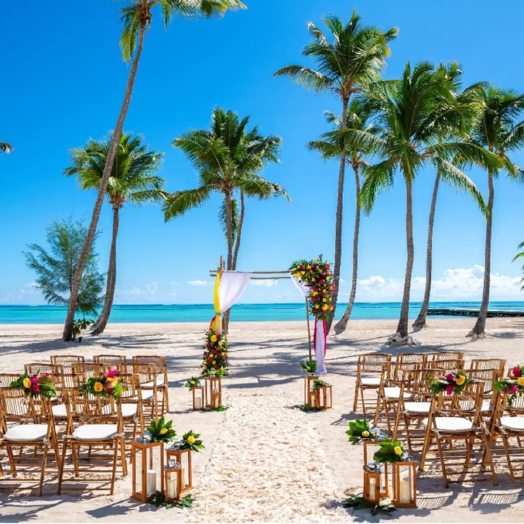 Beach wedding ceremony with bamboo chairs and palm trees at Hyatt Zilara Cap Cana, Punta Cana