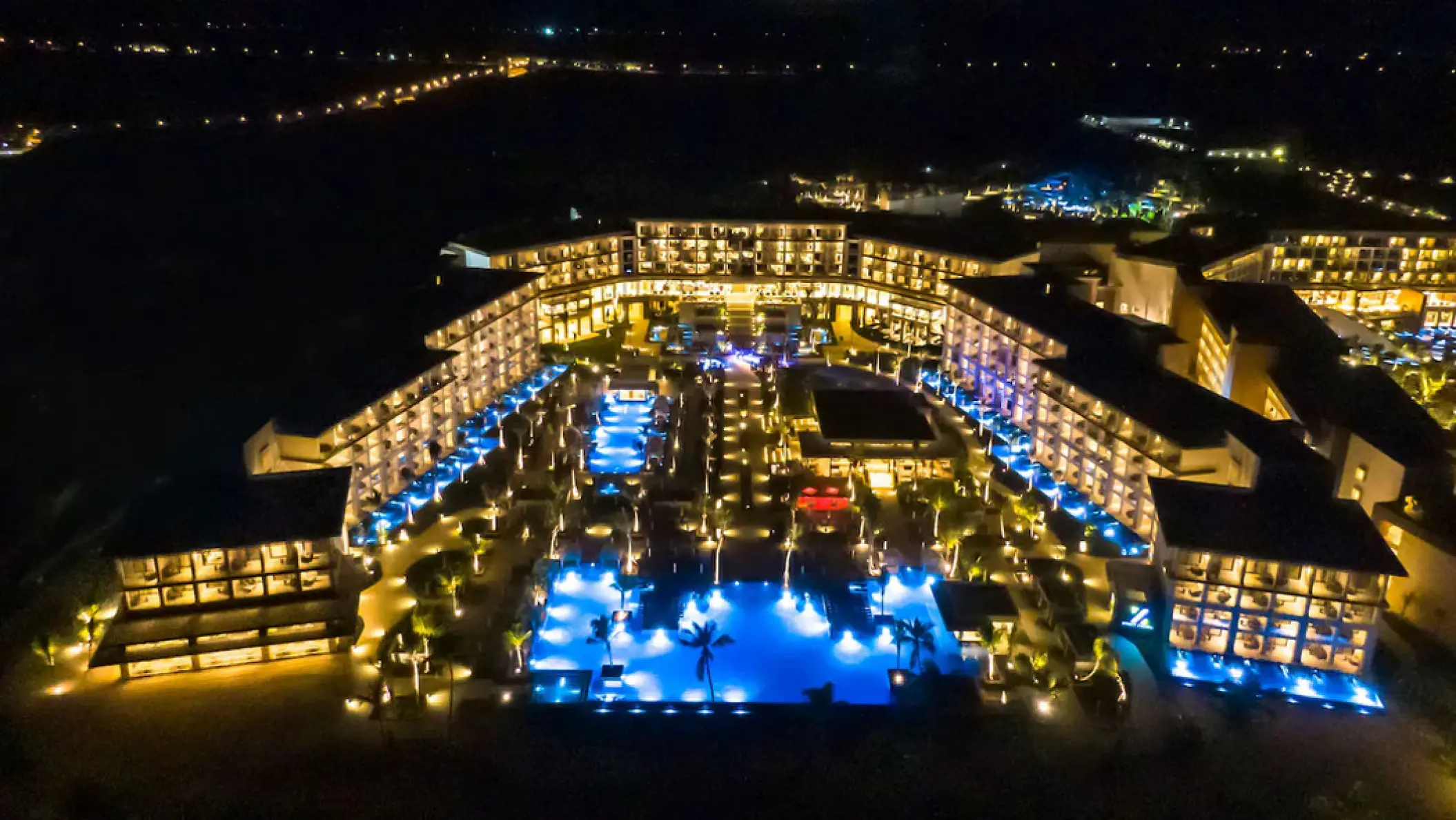 Aerial view of Hyatt Zilara Cap Cana grounds and illuminated pools at night, Punta Cana