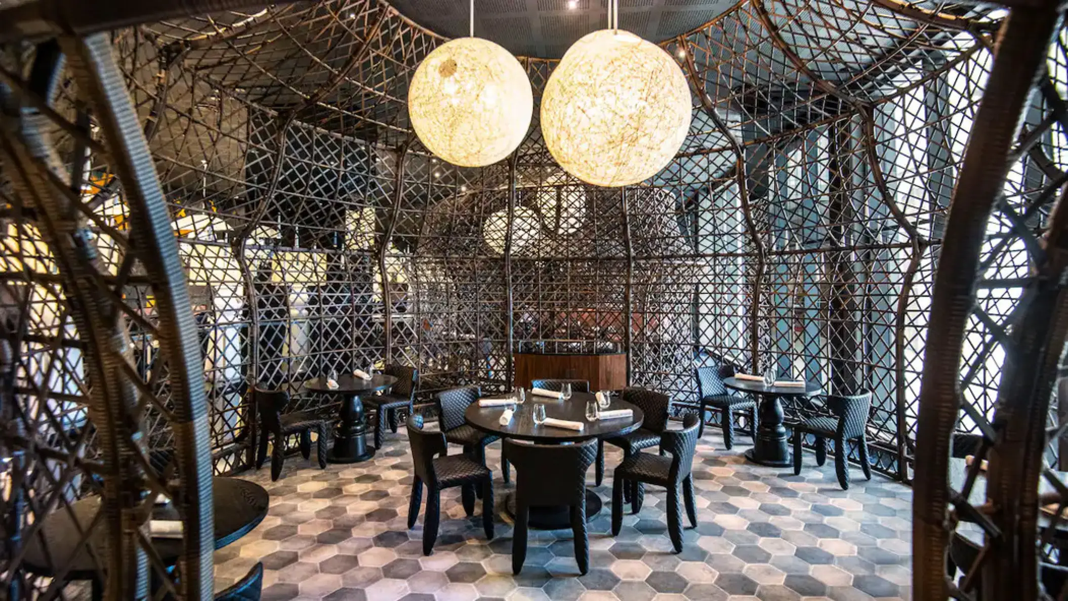 Brando's restaurant with woven cage-like structures and orb lighting at Hyatt Zilara Cap Cana, Punta Cana