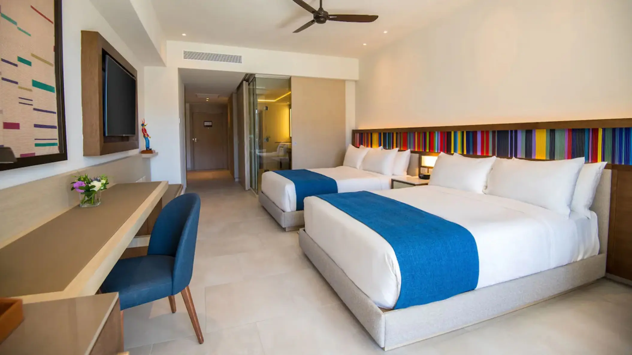 Double junior suite with blue accents and a desk at Hyatt Zilara Cap Cana, Punta Cana
