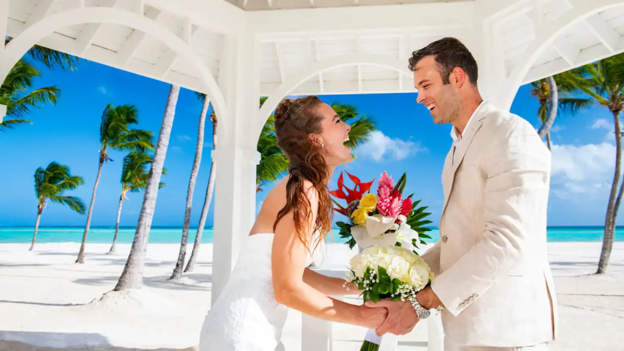 Laughing couple at a beach gazebo wedding ceremony at Hyatt Zilara Cap Cana, Punta Cana