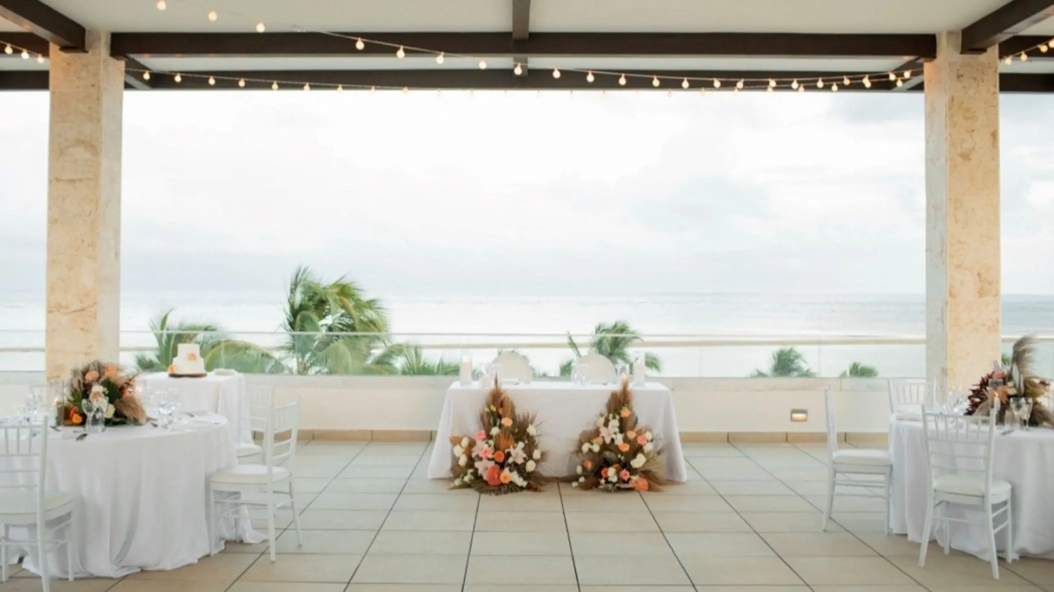Rooftop terrace wedding reception with floral sweetheart table at Hyatt Zilara Cap Cana, Punta Cana