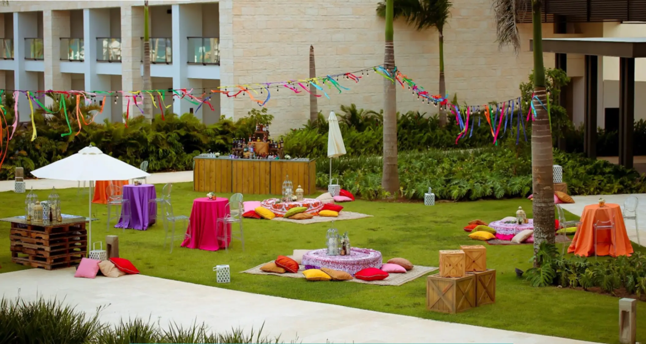 Colorful wedding reception setup with picnic floor seating on the Santiago Lawn at Hyatt Zilara Cap Cana, Punta Cana