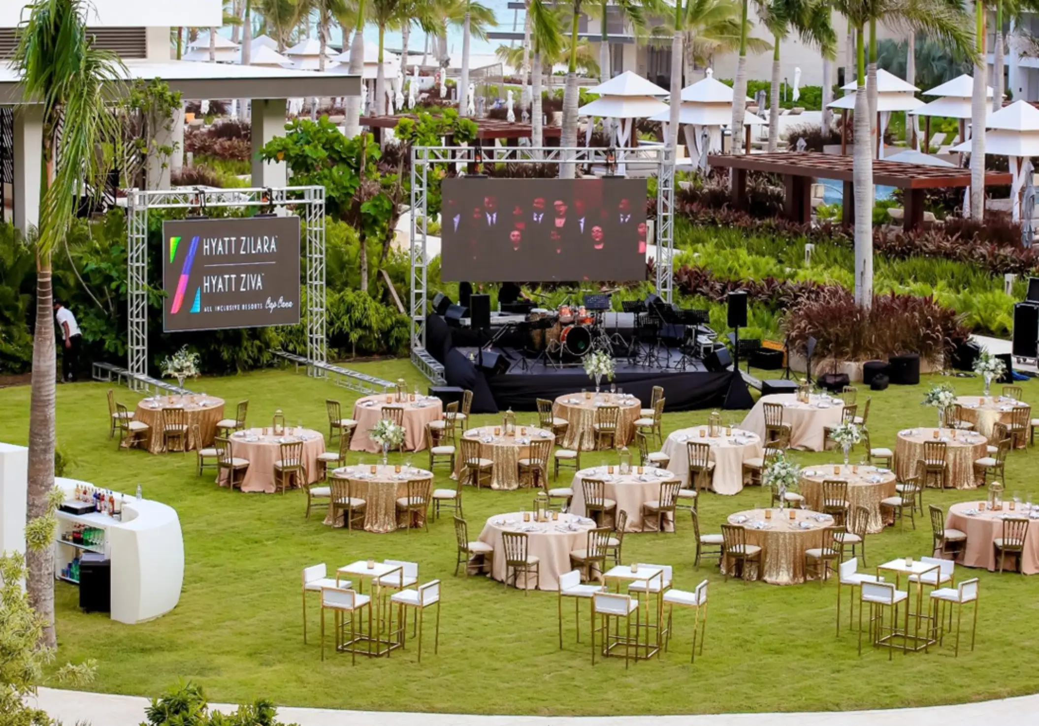 Waves Lawn wedding reception with stage and large screen at Hyatt Zilara Cap Cana, Punta Cana