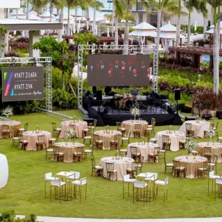 Waves Lawn wedding reception with stage and large screen at Hyatt Zilara Cap Cana, Punta Cana
