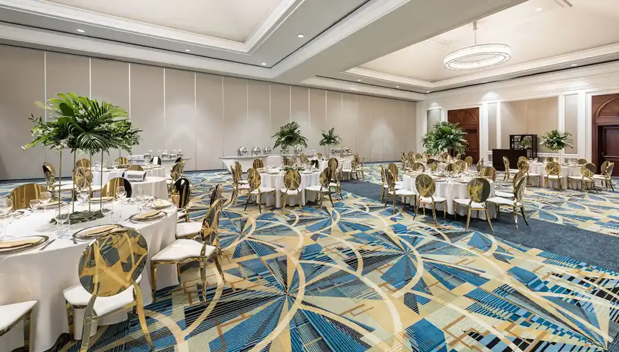 Indoor wedding reception setup with gold chairs and tropical greenery at Hyatt Zilara Rose Hall, Montego Bay