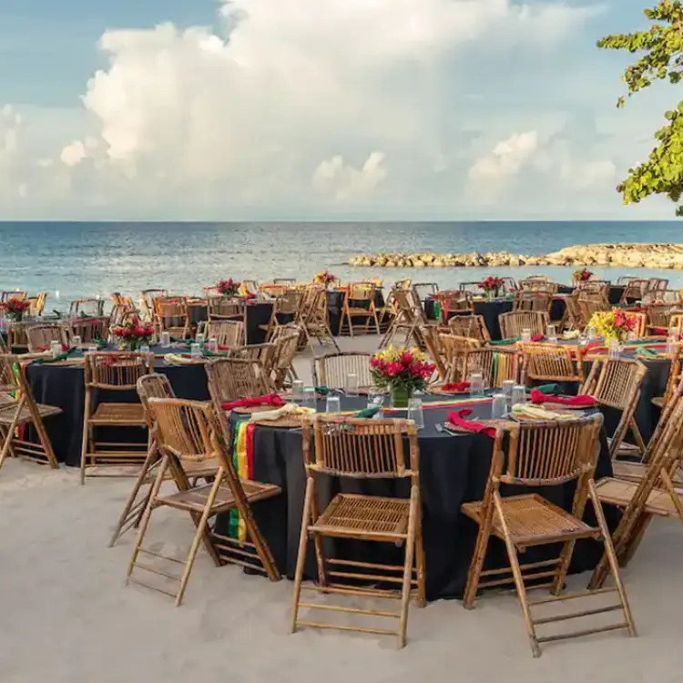 Beachfront wedding reception setup with bamboo chairs at Hyatt Zilara Rose Hall, Montego Bay