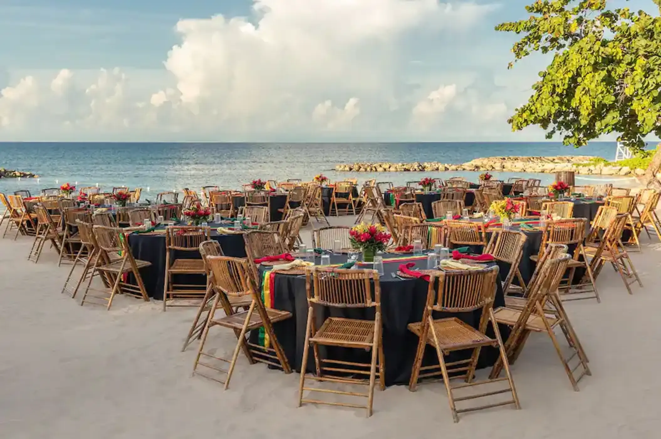 Beachfront wedding reception setup with bamboo chairs at Hyatt Zilara Rose Hall, Montego Bay