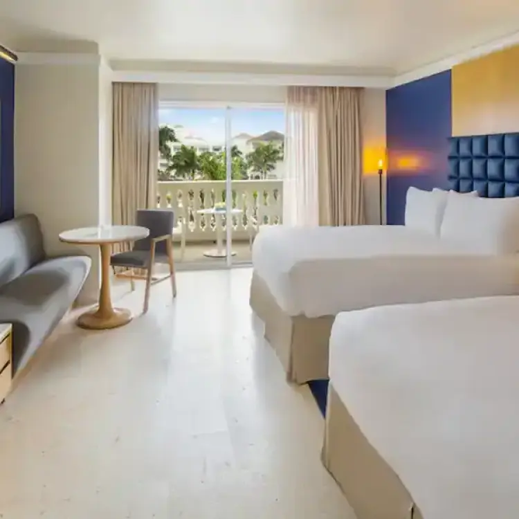 Modern suite with two beds and a private balcony at Hyatt Zilara Rose Hall, Montego Bay