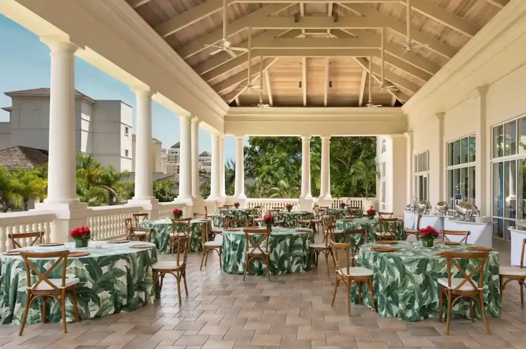 Terrace wedding reception with tropical green linens at Hyatt Zilara Rose Hall, Montego Bay