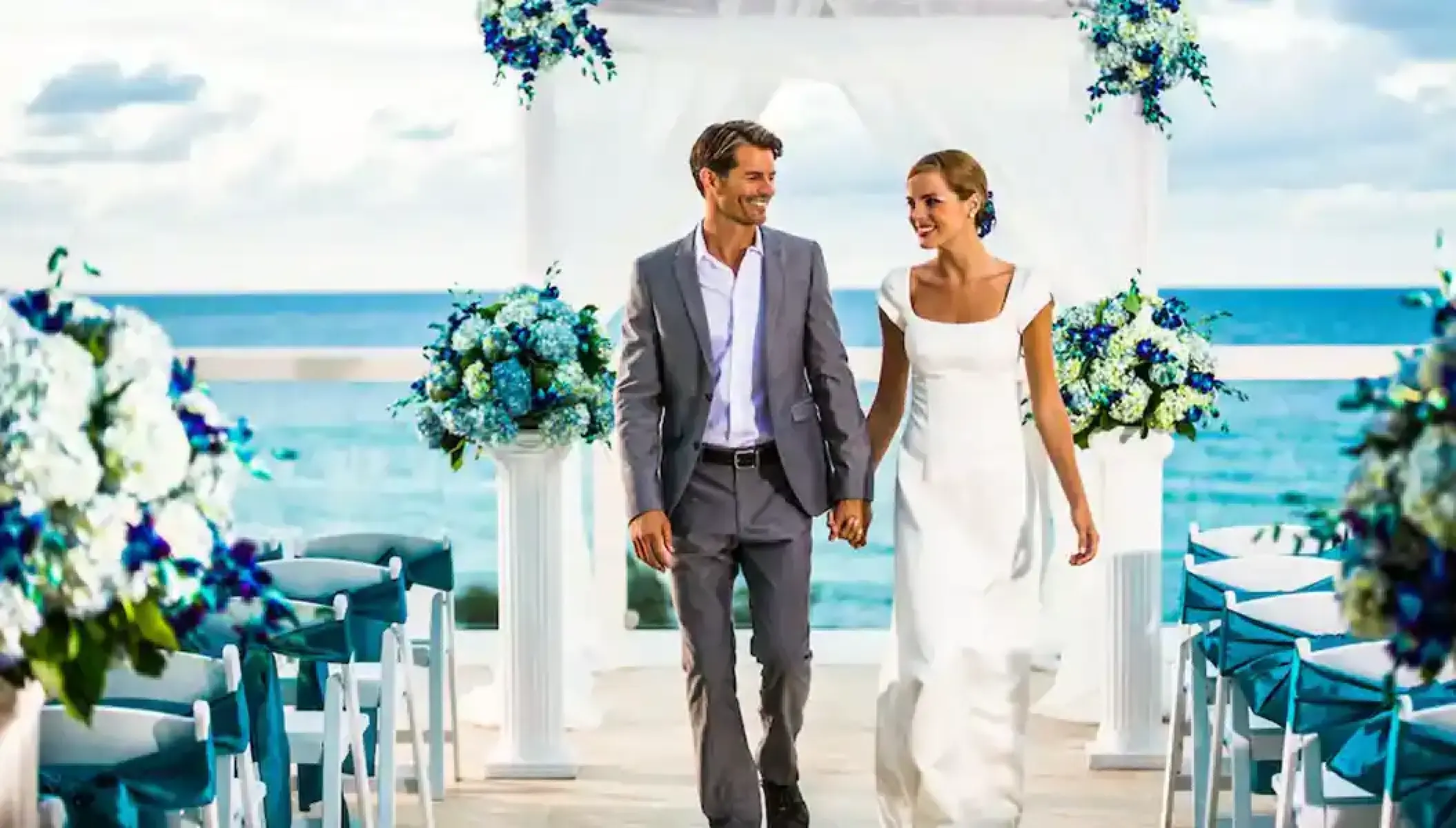 Bride and groom walking down the aisle at an oceanfront wedding ceremony at Hyatt Zilara Rose Hall, Montego Bay