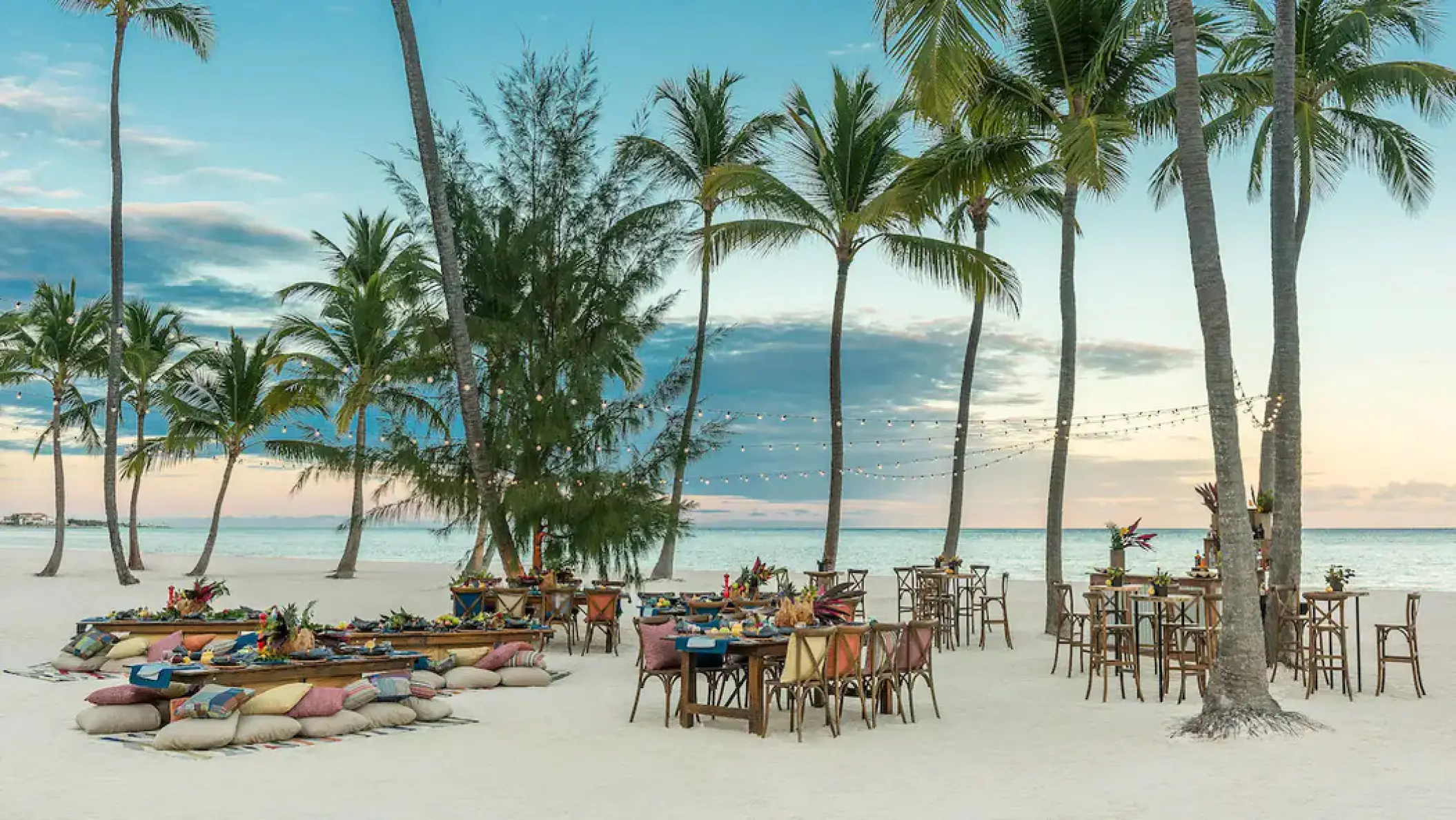 Beachfront wedding reception setup with string lights and palm trees at Hyatt Ziva Cap Cana, Punta Cana