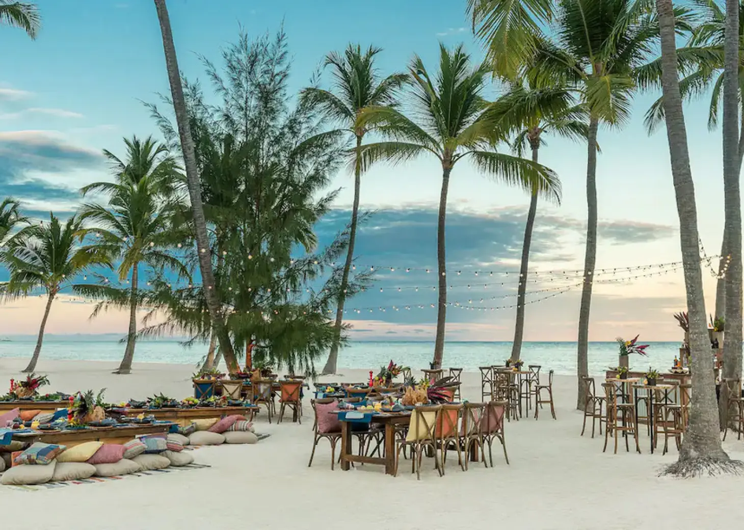Beachfront wedding reception setup with string lights and palm trees at Hyatt Ziva Cap Cana, Punta Cana
