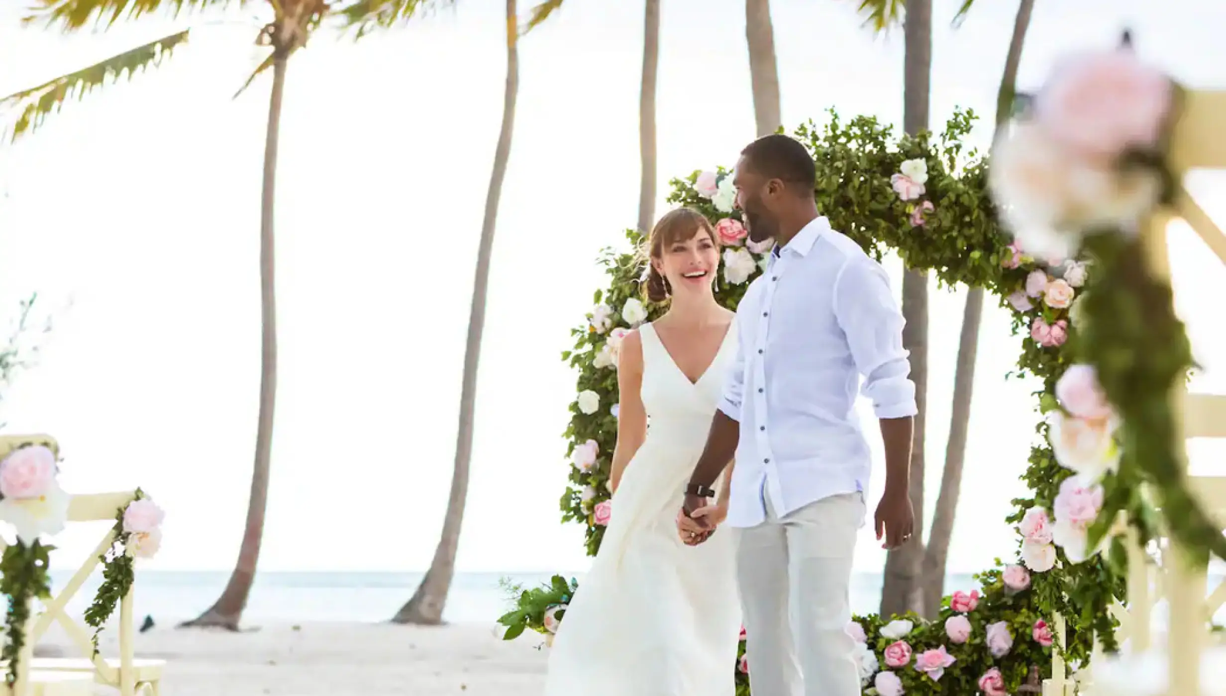 Bride and groom walking at their beach ceremony venue at Hyatt Ziva Cap Cana, Punta Cana