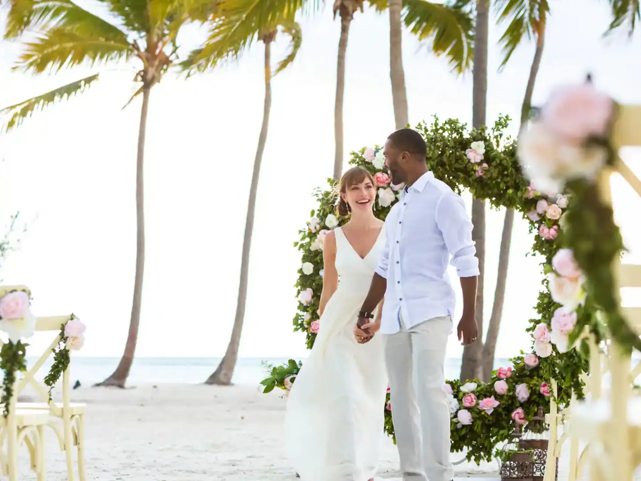 Bride and groom walking at their beach ceremony venue at Hyatt Ziva Cap Cana, Punta Cana