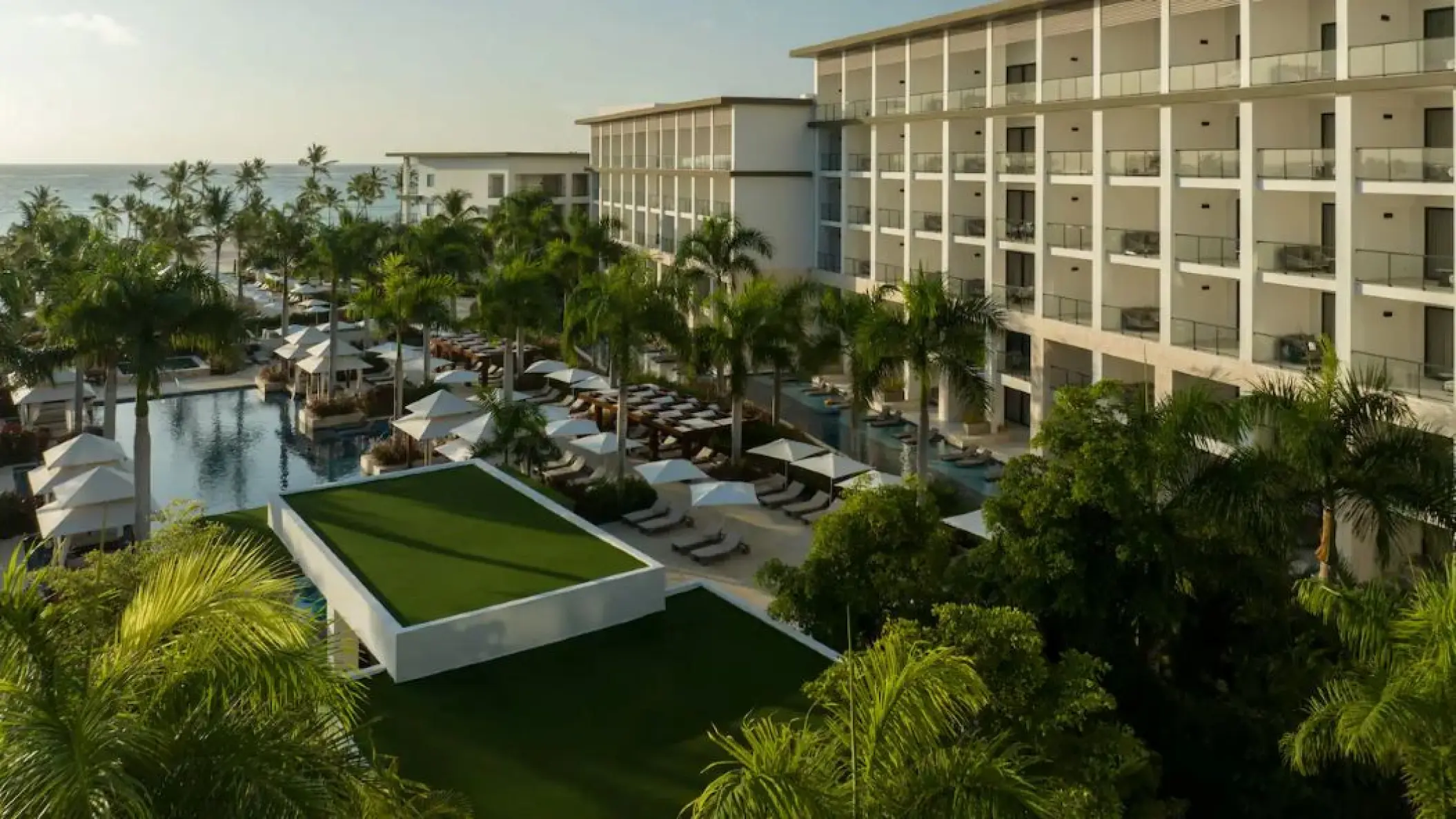Hyatt Ziva Cap Cana exterior view of pools, palm trees, and modern guest suites, Punta Cana
