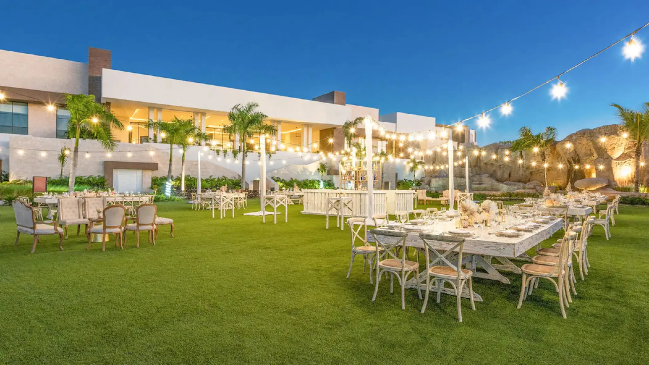 Evening lawn wedding reception with string lights at Hyatt Ziva Cap Cana, Punta Cana
