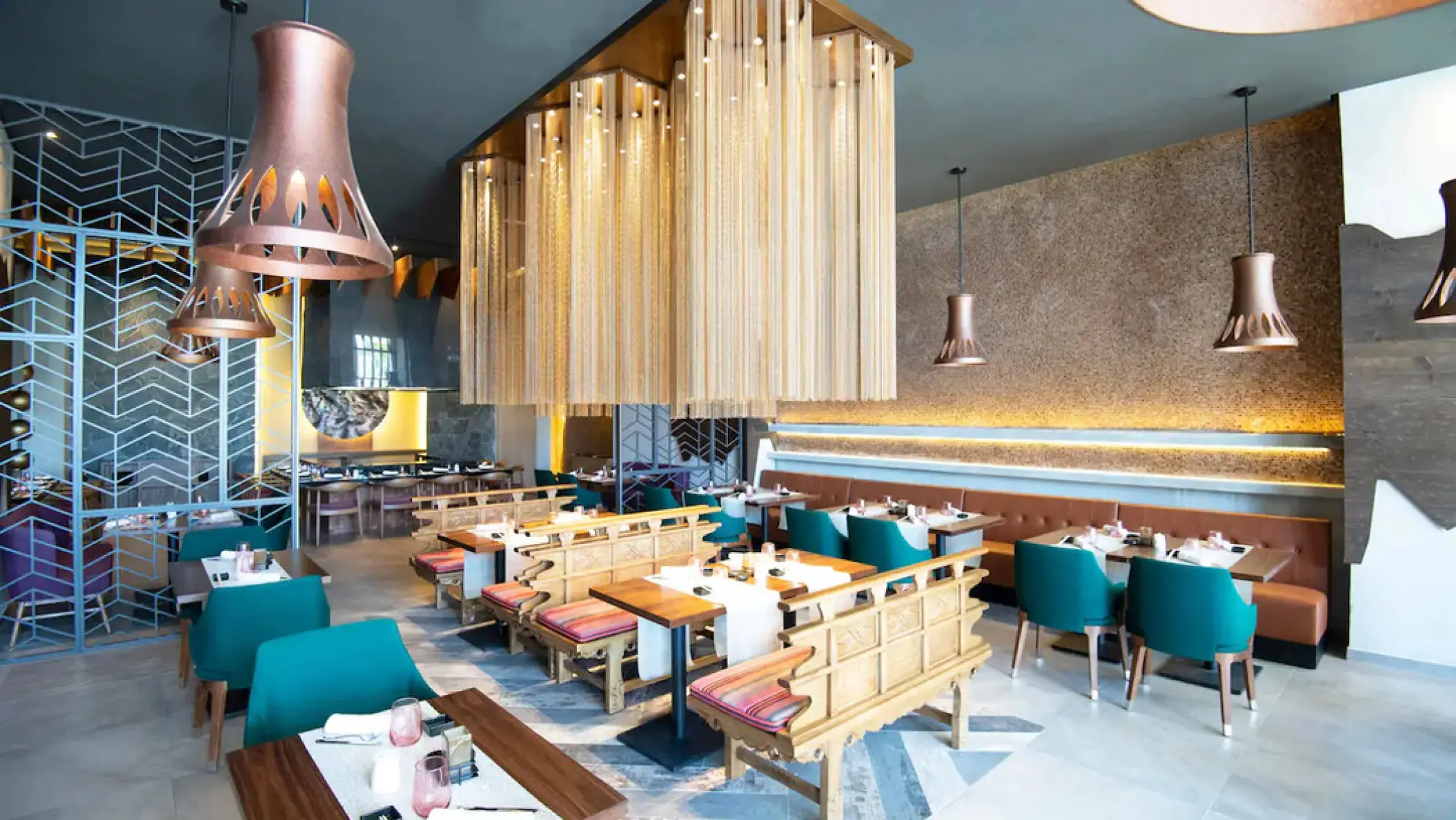 Tempest Table restaurant dining area with teal chairs at Hyatt Ziva Cap Cana, Punta Cana