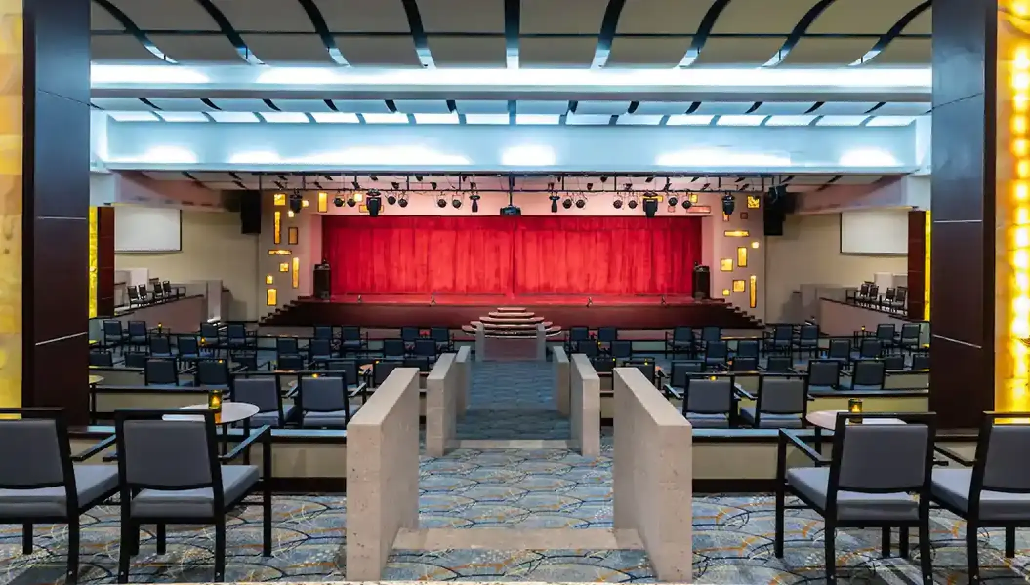 Grand theater with red curtains and tiered seating at Hyatt Ziva Los Cabos, Cabo San Lucas