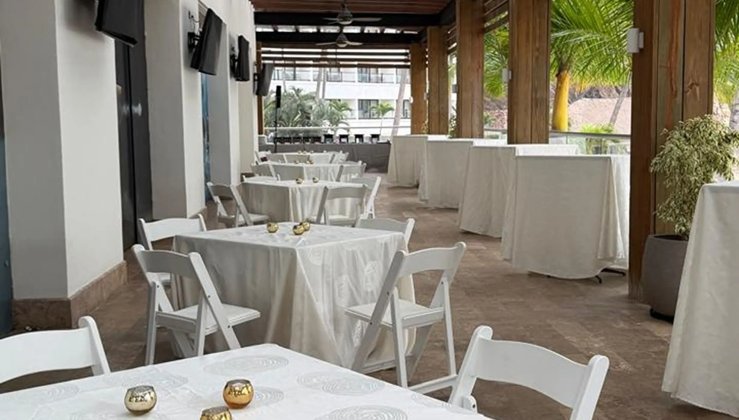 Covered wedding reception terrace setup with white linens at Hyatt Ziva Puerto Vallarta