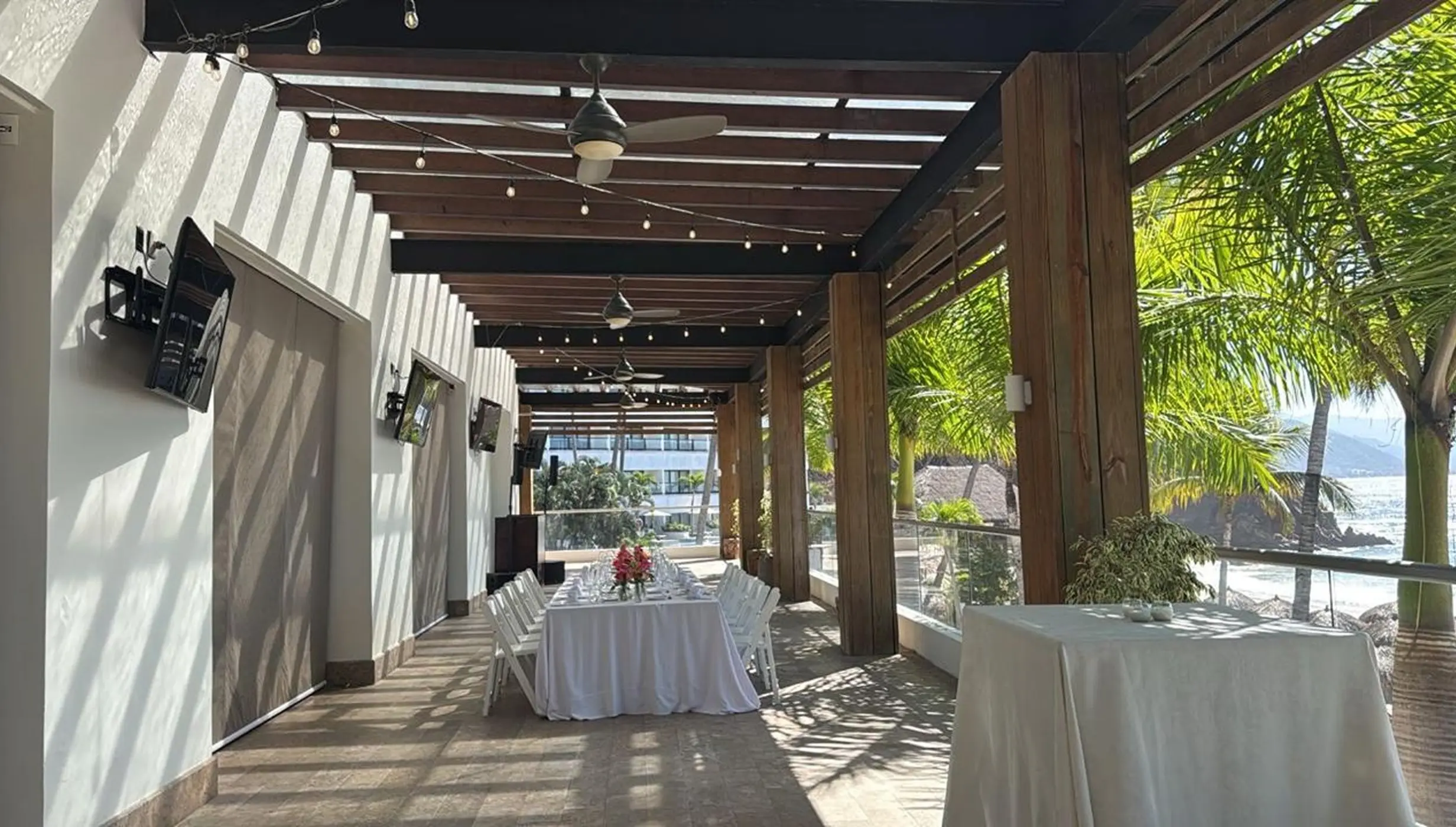 Shaded terrace wedding reception setup with ocean views at Hyatt Ziva Puerto Vallarta