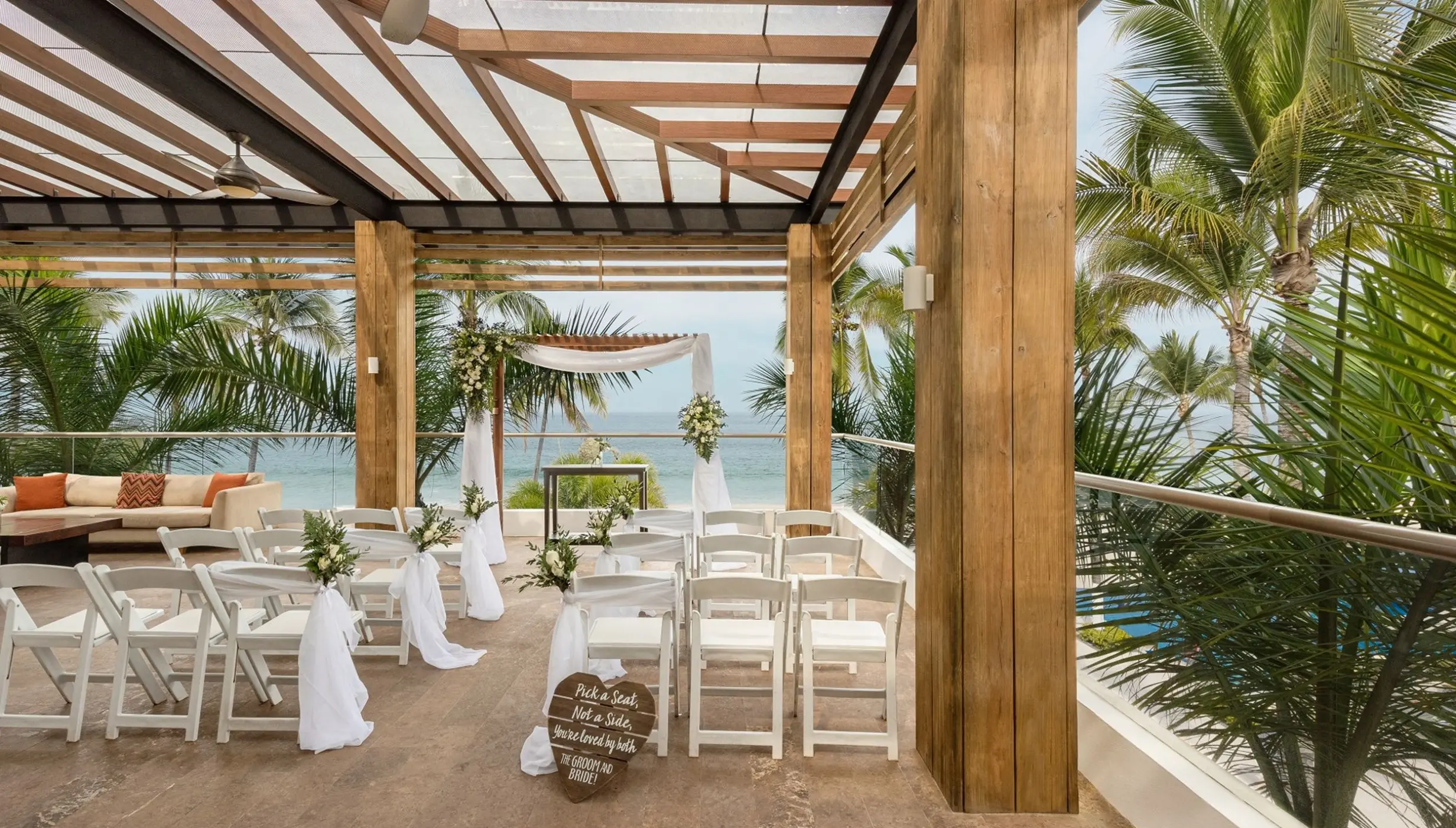 Terrace wedding ceremony setup under a wooden pergola at Hyatt Ziva Puerto Vallarta