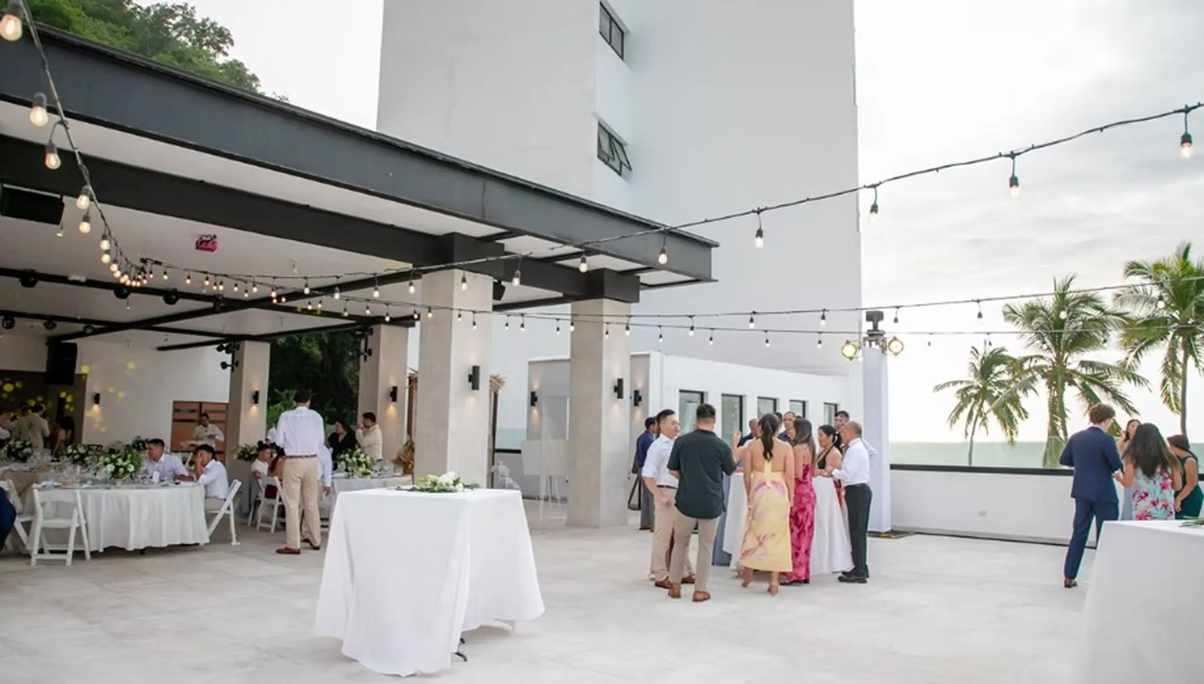 Outdoor wedding reception with string lights on the terrace at Hyatt Ziva Puerto Vallarta