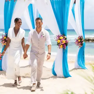 Bride and groom walking from a beach ceremony at Hyatt Ziva Rose Hall, Montego Bay
