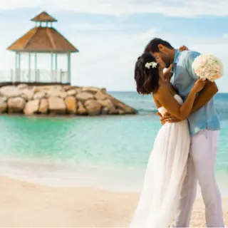 Bride and groom kissing on the beach at Hyatt Ziva Rose Hall, Montego Bay