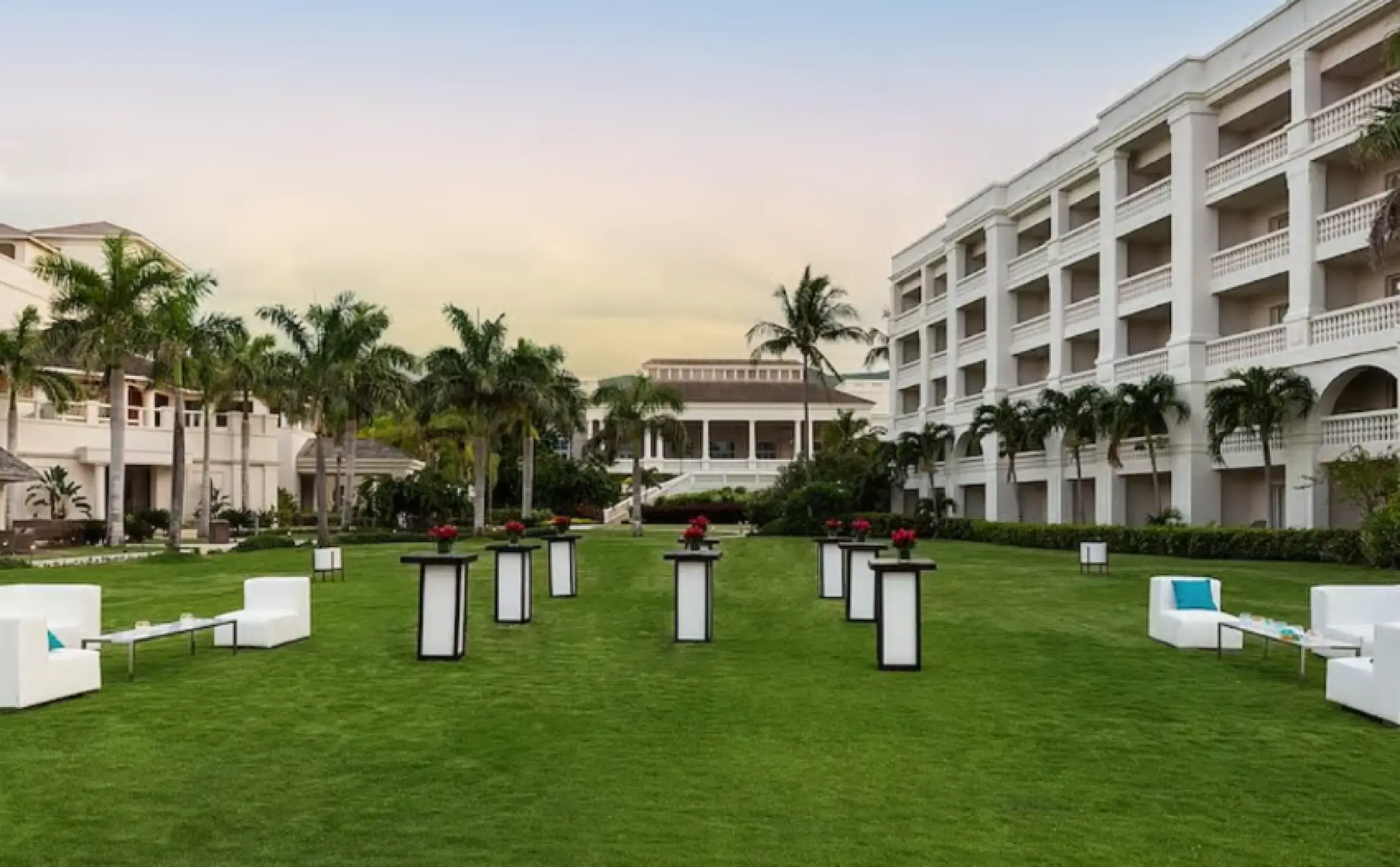 East Lawn wedding reception setup with white lounge furniture at Hyatt Ziva Rose Hall, Montego Bay