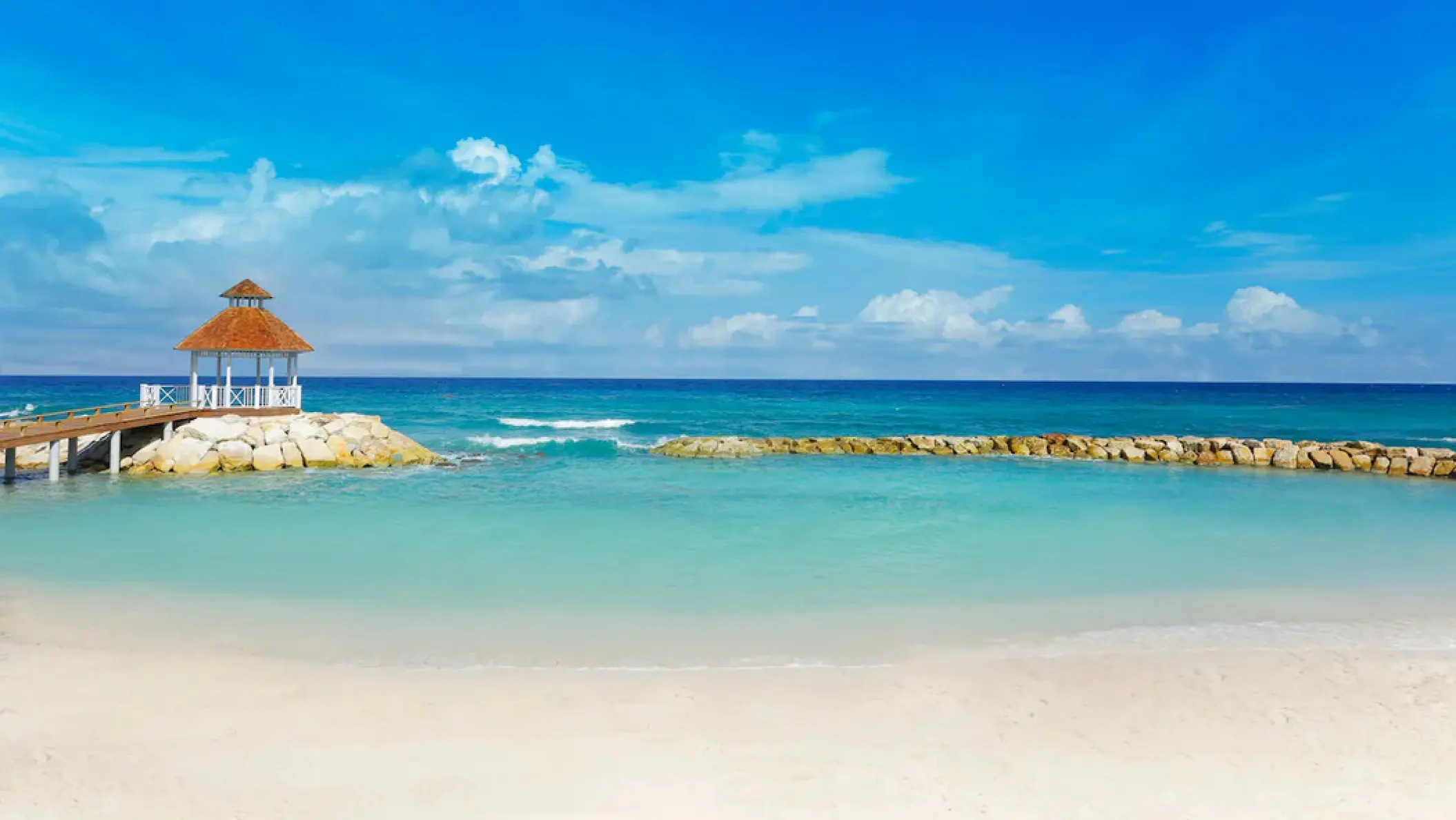 White sand beach and oceanfront gazebo at Hyatt Ziva Rose Hall, Montego Bay