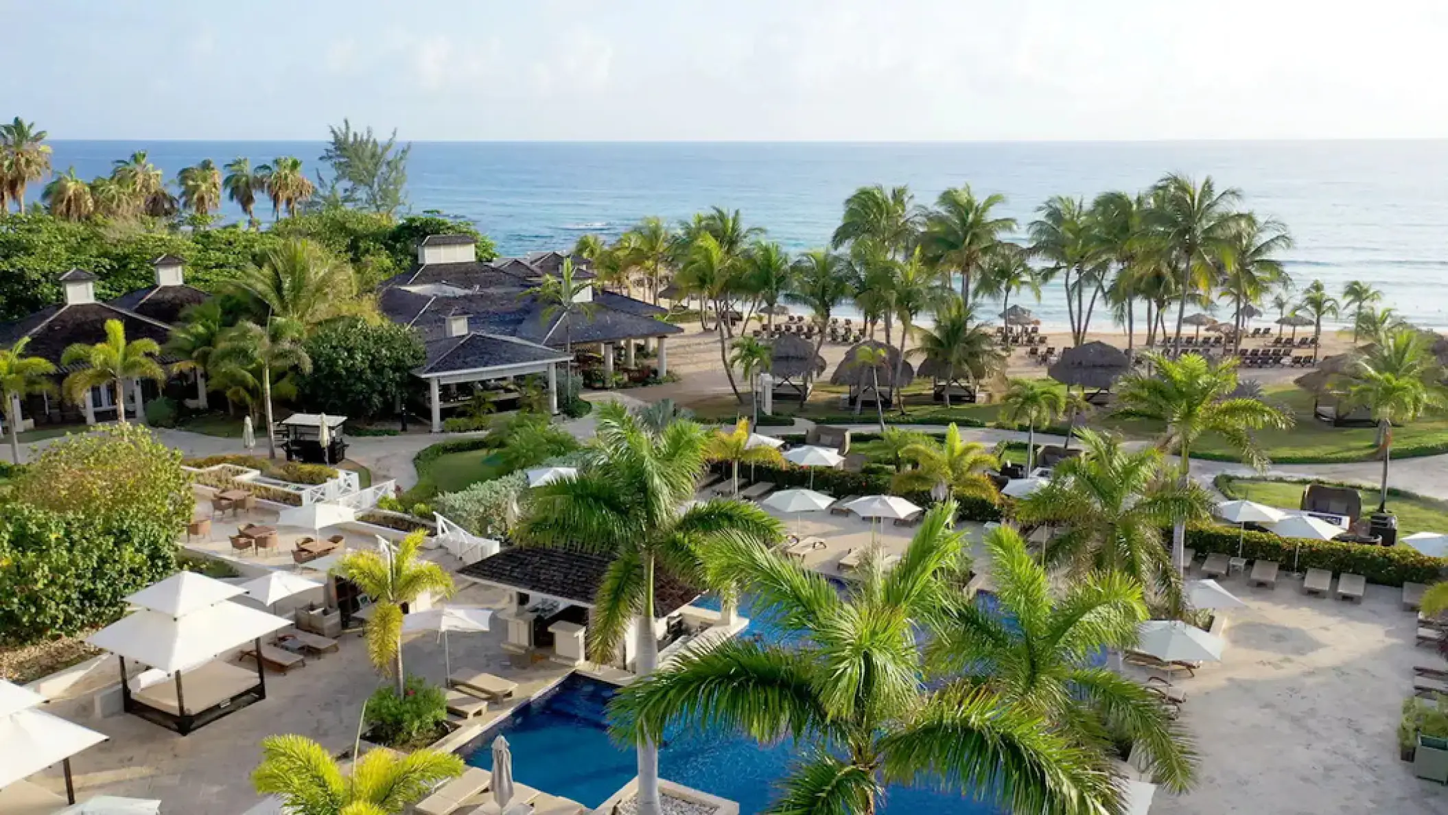 Aerial view of Hyatt Ziva Rose Hall pool, palm trees, and beach, Montego Bay