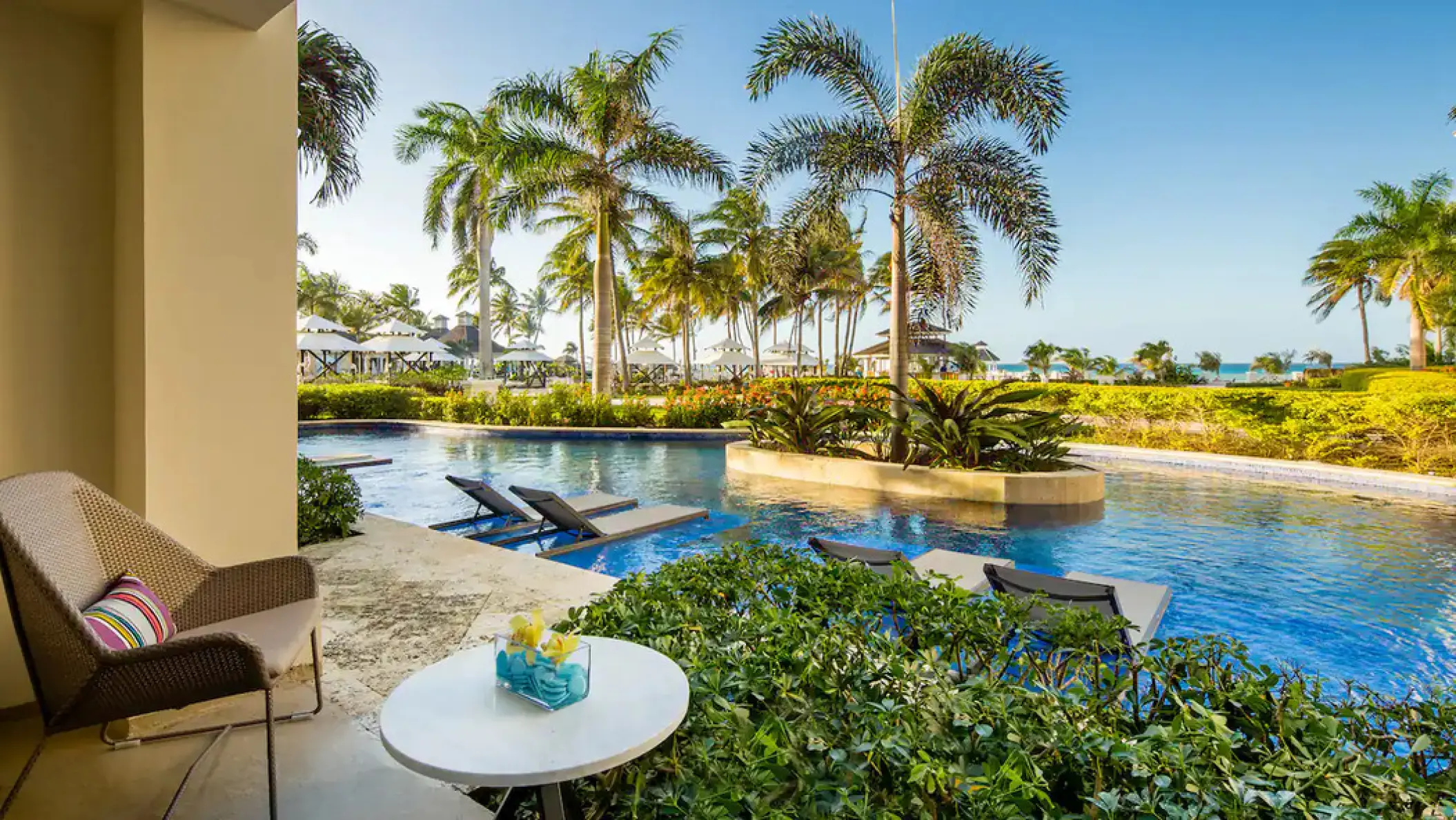 Swim-out suite terrace with pool and tropical palm trees at Hyatt Ziva Rose Hall, Montego Bay