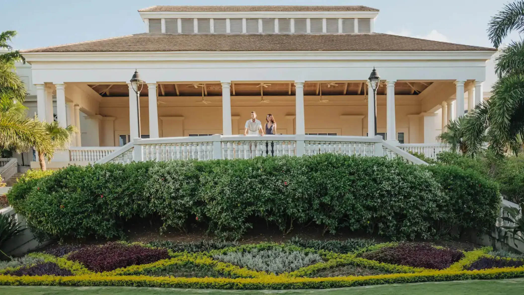 A couple standing on the grand terrace at Hyatt Ziva Rose Hall, Montego Bay